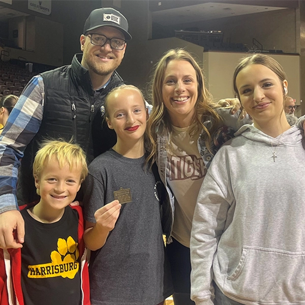 Travis Jensen and his family smile together