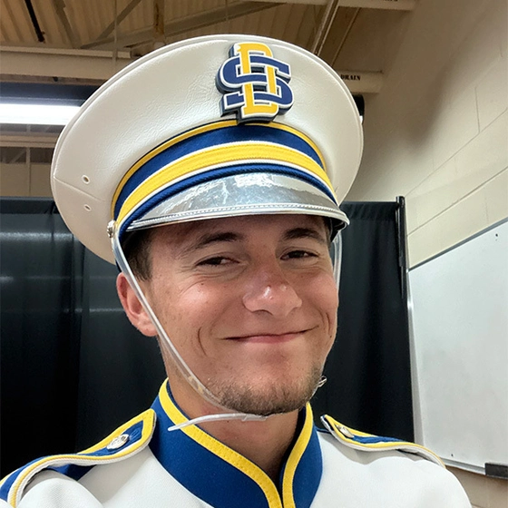 A selfie of Evan Bartelt wearing his marching band hat.