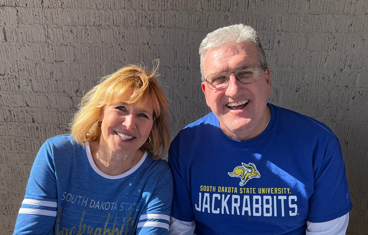 Elaine and Jerome Garry smiling together, wearing Jackrabbit gear.