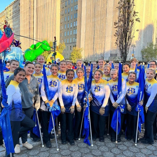 The flag team with the Pride of the Dakotas smiles before the Macy's Thanksgiving Day Parade.