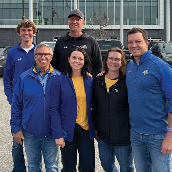 A group of six people smiling for the camera.