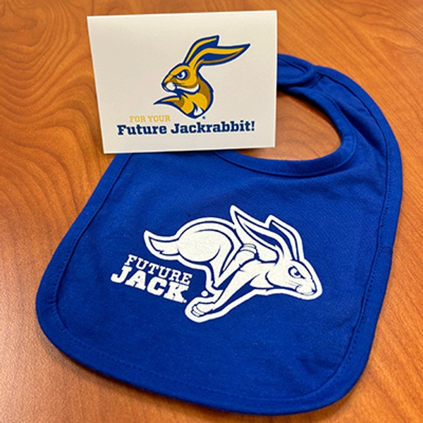 photo of blue "Future Jack" bib lying on a table with a white "For your Future Jackrabbit" card
