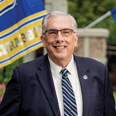 A headshot of South Dakota State University President Barry H. Dunn outside the president's home.