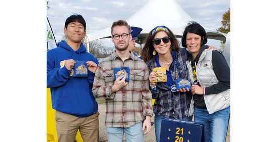 Vanessa Klemme VanDeWiele and Daewon Kim smile with two other individuals, all holding bean bags after playing a game.