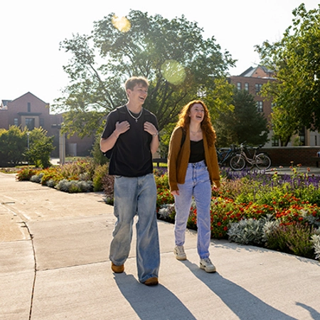 Group of two SDSU students walking together outside of Rotunda