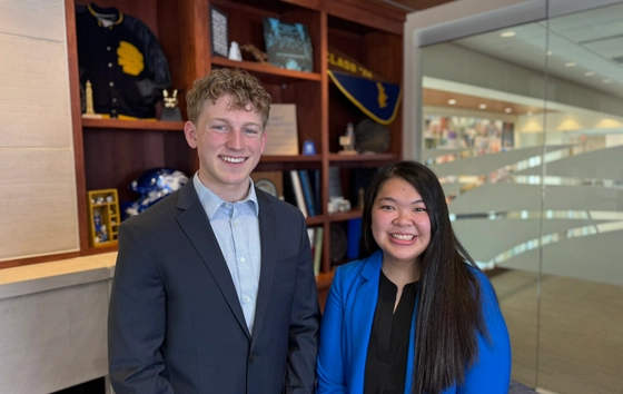 Two students smiling at the camera