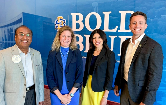 Dr. Sanjeev Kumar, Erin Glidden, Dr. Christine Garst-Santos, and Dr. Evan Ortlieb smiling together at the camera