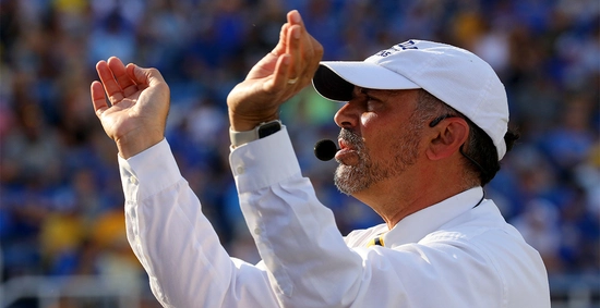 Kevin Kessler directs The Pride of the Dakotas at a football game.